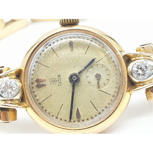 43 - 18ct gold Tudor vintage ladies watch, diamonds on each side of face, comes with safety chain and wor... 