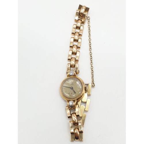 43 - 18ct gold Tudor vintage ladies watch, diamonds on each side of face, comes with safety chain and wor... 