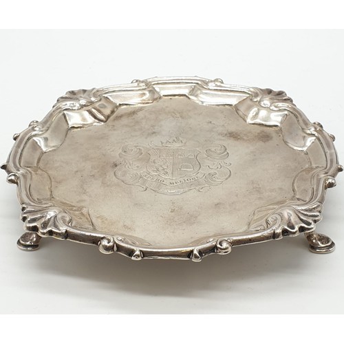 94 - Early English silver tray with 3 legs scallop edge and central armorial crest, 15.5cm diameter appro... 