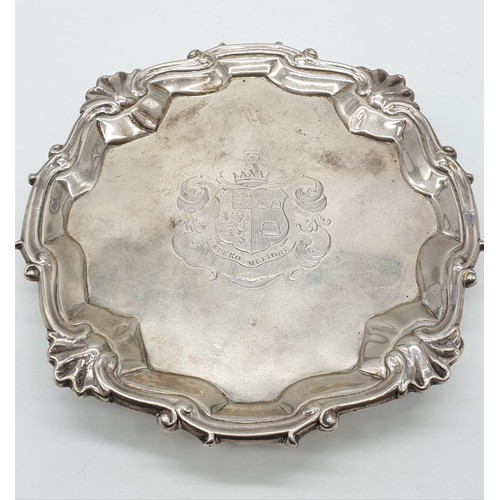 94 - Early English silver tray with 3 legs scallop edge and central armorial crest, 15.5cm diameter appro... 