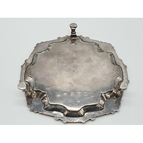 94 - Early English silver tray with 3 legs scallop edge and central armorial crest, 15.5cm diameter appro... 