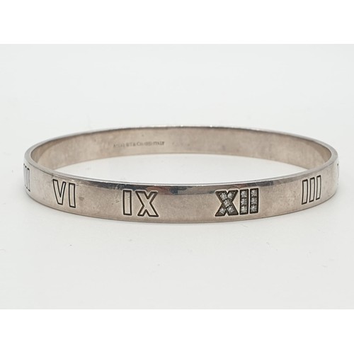 104 - Tiffany silver and diamond bangle with Roman numerals, weight 21.6g and 63mm width.