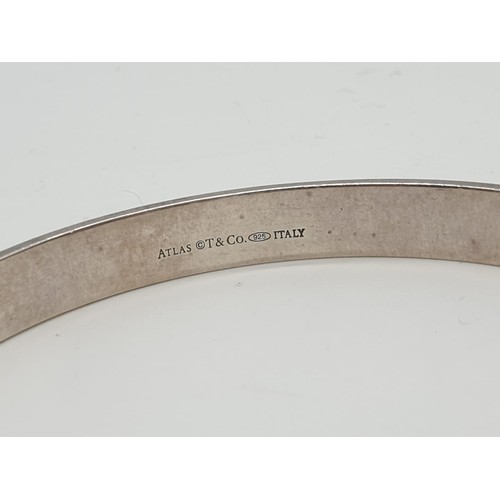 104 - Tiffany silver and diamond bangle with Roman numerals, weight 21.6g and 63mm width.