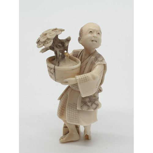 169 - 19th century ivory Japanese Meiji Period Okimono gardener figure, 26.7g weight and 6.5cm tall, one f... 