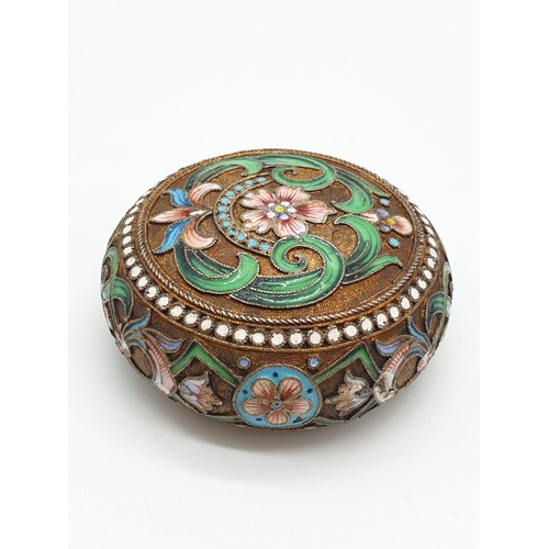 255 - Russian gilt enamel pill box with fitted lid surrounded by seed pearls and colourful enamel, 5cm dia... 