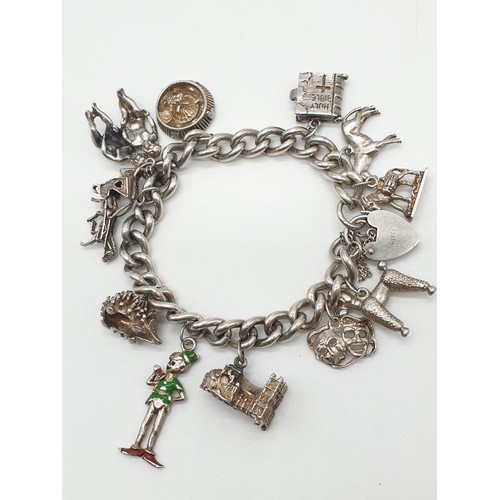 302 - Vintage silver charm bracelet with 12 charms and heart padlock, weight 63.65g and 18cm long approx