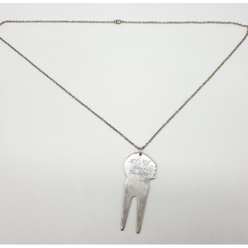 356 - A golfing tool called a pitch repairer (dated 1999) on a 70cm long silver chain, weight 30.53g and p... 