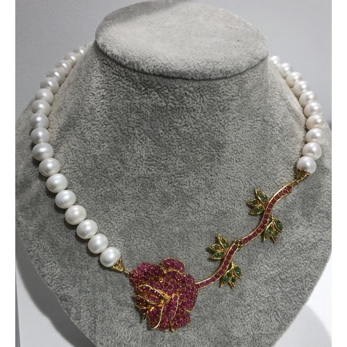 460 - Freshwater pearls necklace set in rubies, emeralds and gold plated silver clasp; around 19inches lon... 