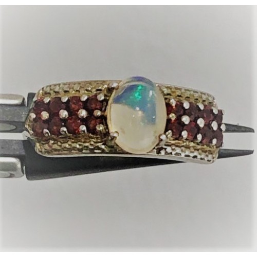 494 - Silver ring with opal 8x6mm and garnets; 3.45g; size R1/2