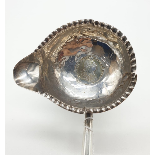 259 - George III silver Ladle with Coin set in the bottom of the bowl, dated 1787, some damage 28g 32cms