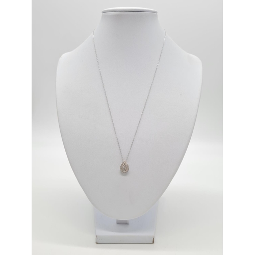 266 - 18k gold and diamond set pendant on a 40cm 9ct gold chain, weight 2g