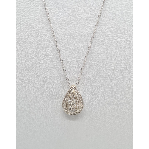 266 - 18k gold and diamond set pendant on a 40cm 9ct gold chain, weight 2g