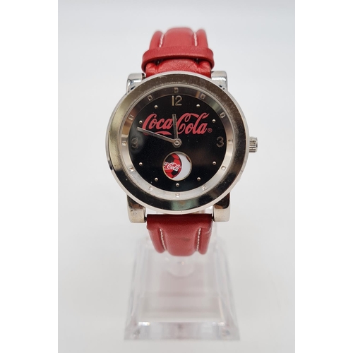 279 - Coca Cola Watch with rotating logo second counter, red leather strap