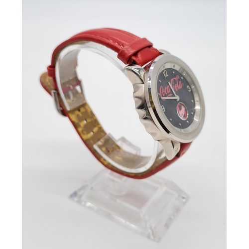 279 - Coca Cola Watch with rotating logo second counter, red leather strap