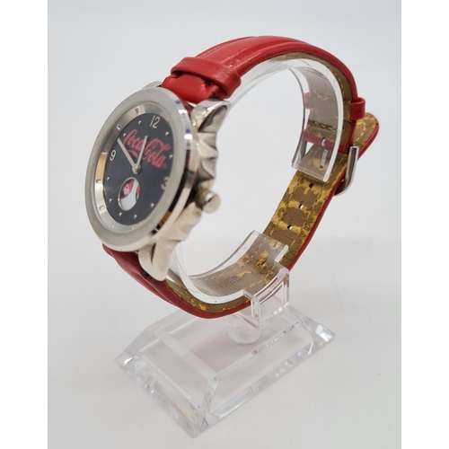 279 - Coca Cola Watch with rotating logo second counter, red leather strap