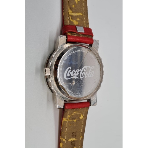 279 - Coca Cola Watch with rotating logo second counter, red leather strap