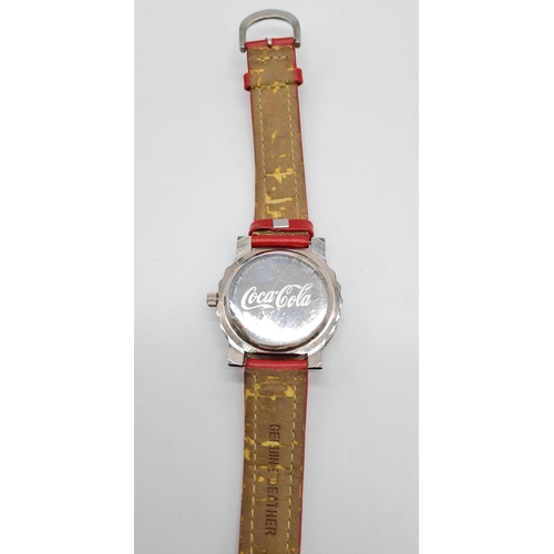 279 - Coca Cola Watch with rotating logo second counter, red leather strap