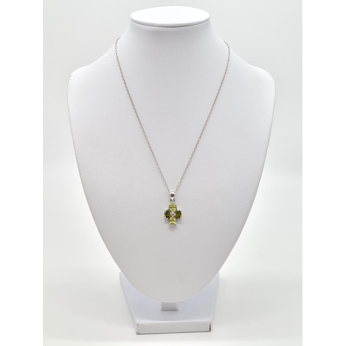 332 - Peridot and citrine silver pendant on a 40cm long silver chain, weight 4.79g and pendant size 20x13m... 