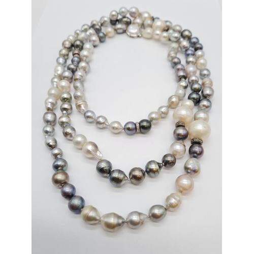 37 - A very long Cartier style pearl necklace set in 14ct gold mother of pearl clasp, various shades of b... 