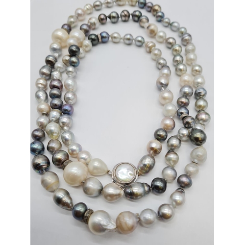 37 - A very long Cartier style pearl necklace set in 14ct gold mother of pearl clasp, various shades of b... 