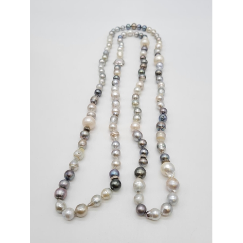 37 - A very long Cartier style pearl necklace set in 14ct gold mother of pearl clasp, various shades of b... 