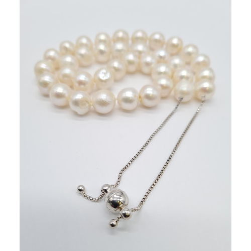 396 - Fresh water pearl necklace set in silver clasp with expandable chain, weight 62.2g approx