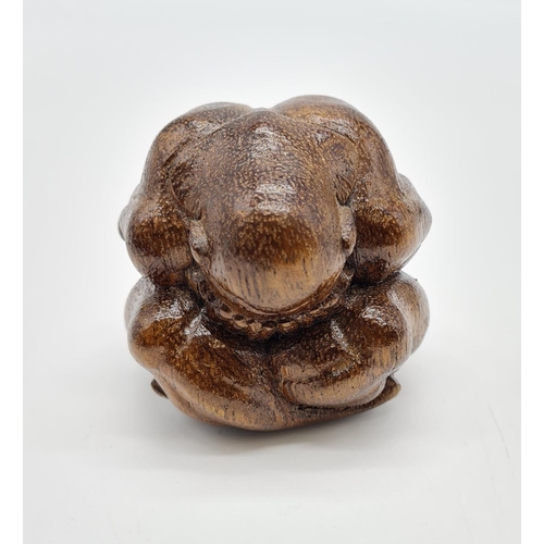 478 - Carved Wooden Effigy of a Buddhist Monk in Contemplation. 7cm diameter