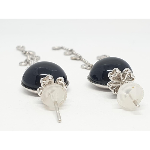 109 - Pair of Onyx and diamond drop earrings set in 18ct gold, weight 10.13g and 7cm drop approx