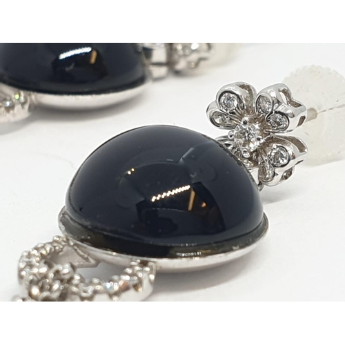 109 - Pair of Onyx and diamond drop earrings set in 18ct gold, weight 10.13g and 7cm drop approx