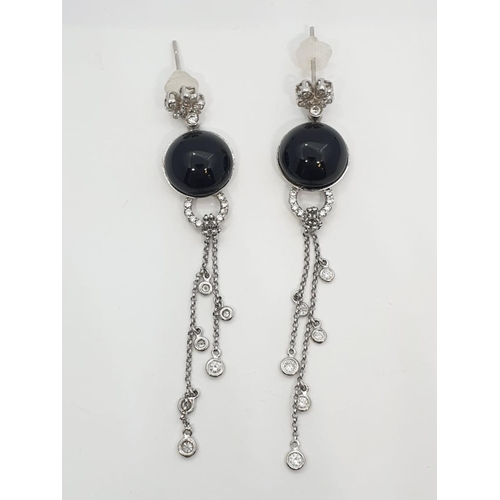 109 - Pair of Onyx and diamond drop earrings set in 18ct gold, weight 10.13g and 7cm drop approx