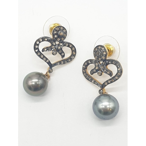 128 - Pair of South sea pearl earrings set in rose diamonds , 3cm drop and pearl size 8mm approx