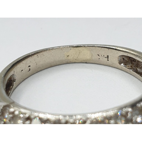 206 - 18ct white gold diamond half eternity ring, weight 2.6g and size L