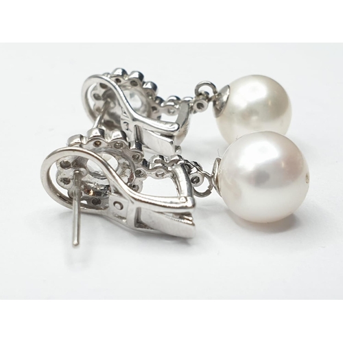 216 - Pair of 18ct gold pearl and white sapphire drop earrings in floral design, weight 6g and 2.5cm drop ... 