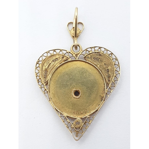 218 - 18ct yellow gold vintage heart shaped Mary pendant with filigree edged work, weight 2.43g and 2.5cm ... 