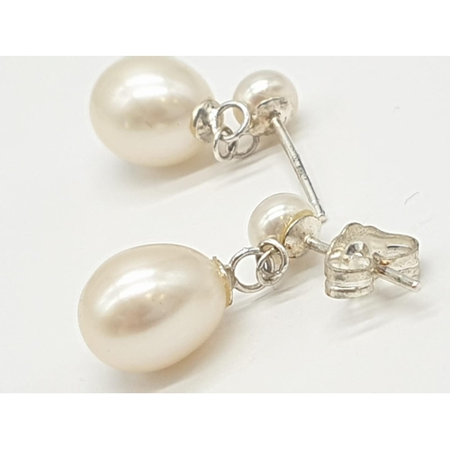 374 - 2x pairs of silver pearl drop earrings, weight 5.52g  (1 back missing)