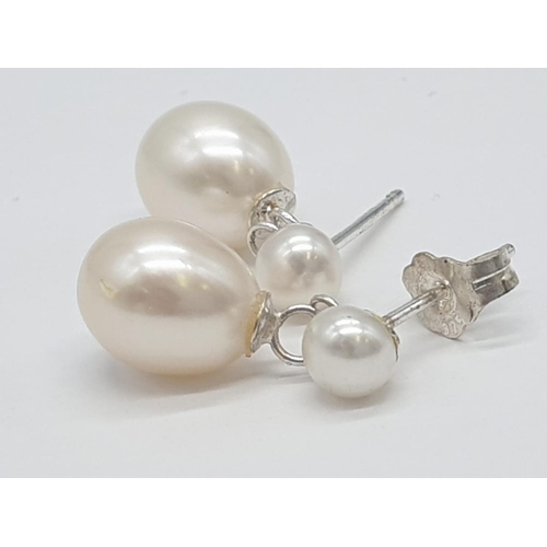 374 - 2x pairs of silver pearl drop earrings, weight 5.52g  (1 back missing)