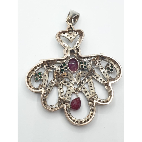 668 - Ruby, diamond and emerald on silver PENDANT. 19.7g   5.4cm  6cm drop.