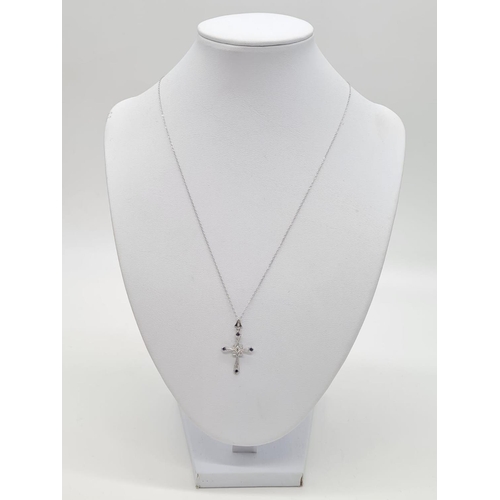 142 - Art deco style sapphire and diamond cross pendant set in 18ct gold, on a 46cm long 9ct gold chain, t... 