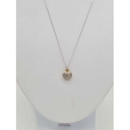 224 - 18ct gold diamond set heart shaped pendant set on 46cm long 9ct gold chain, weight 1.87g approx