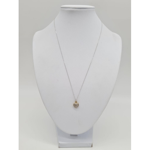 224 - 18ct gold diamond set heart shaped pendant set on 46cm long 9ct gold chain, weight 1.87g approx