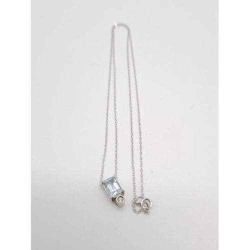 228 - 18ct gold aquamarine pendant set on a a 40cm long 9ct gold chain, weight 1.96g and aquamarine 4x6mm ... 