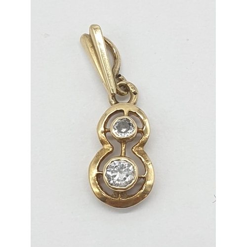 238 - 18ct yellow gold diamond set pendant in the shape of number 8, approx 1cm long