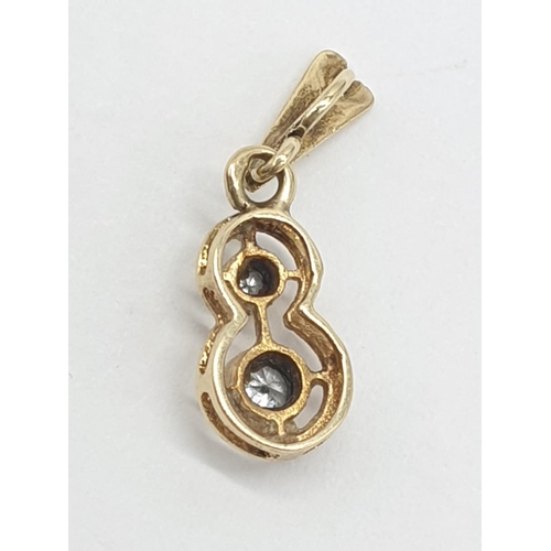 238 - 18ct yellow gold diamond set pendant in the shape of number 8, approx 1cm long