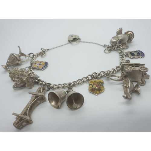 300 - Silver charm bracelet with 11 charms, some are opening up charms and heart padlock, weight 53.28g