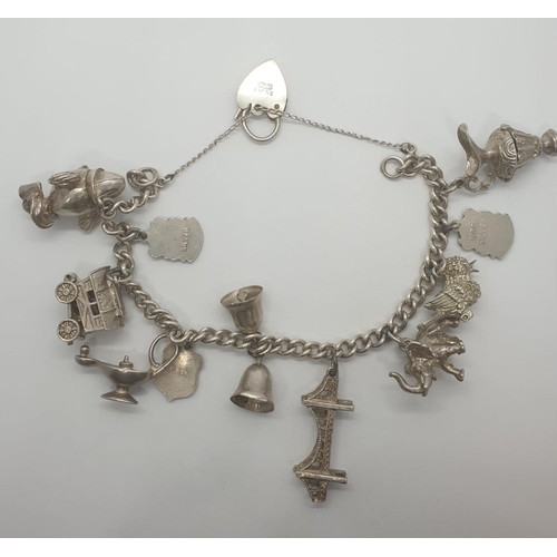 300 - Silver charm bracelet with 11 charms, some are opening up charms and heart padlock, weight 53.28g