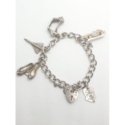 408 - Silver charm bracelet with 6 charms and heart padlock, weight 28.5g a and 16cm long approx