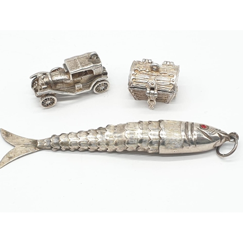 420 - 3x assorted large silver pendant, total weight 24.41g.
Fish pendant 8cm long, treasure trunk opens u... 