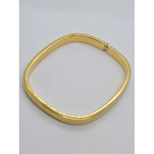 570 - 18ct gold bangle weight 16.7 grams size 6.5 x 5.5cm.