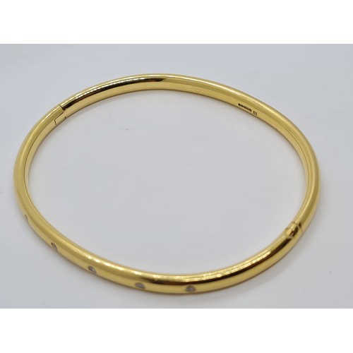 578 - 18ct gold bangle with six small diamonds in a Cartier style weighs 28gm.