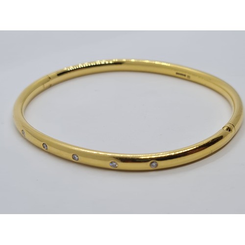 578 - 18ct gold bangle with six small diamonds in a Cartier style weighs 28gm.